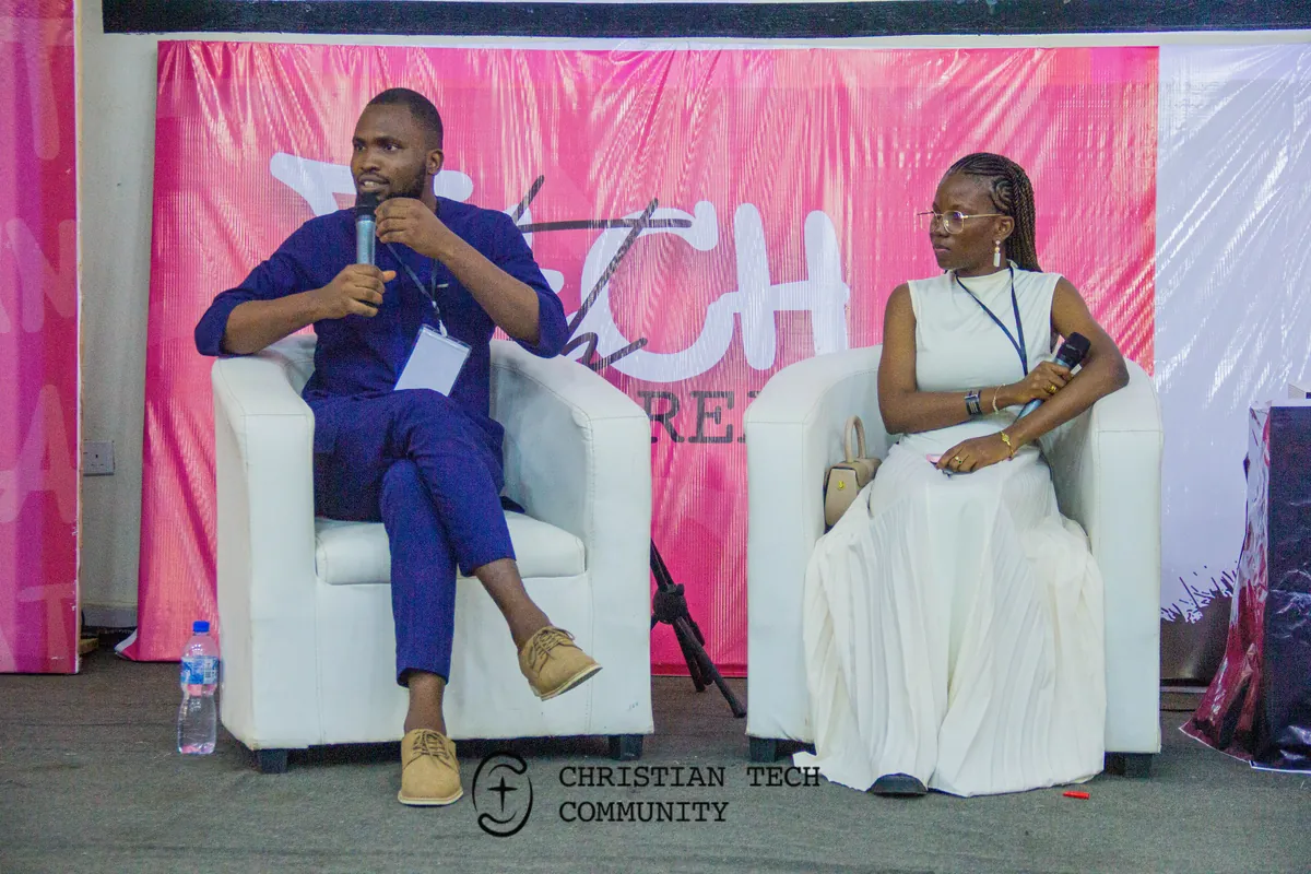 Two speakers talking on white armchairs in front of a pink CTC backdrop at CTC 1.0.