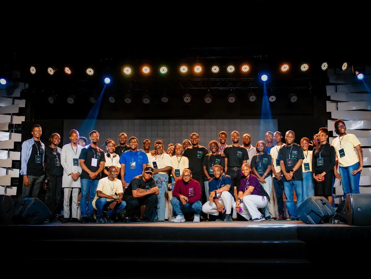 A large group of people standing together on the stage at CTC 2.0, lit from above.